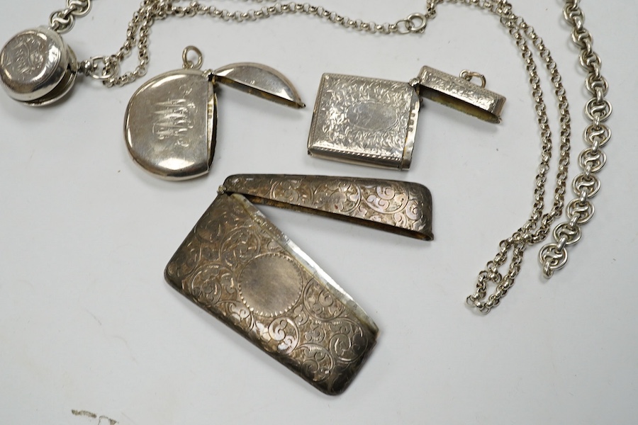 An Edwardian engraved silver sovereign case, Birmingham, 1905, on a silver chain, one other sterling chain, two silver vesta cases and a silver card case. Condition - poor to fair